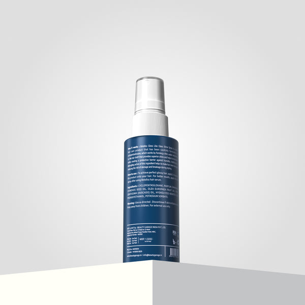 A Botoliss gloss-like shine spray bottle stands on a light-colored surface against the backdrop of a gradient background.