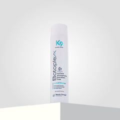 A bottle of Botoplexx K9 Conditioner rests elegantly on a white surface, standing out against a light gray background.