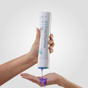 Hands gently squeezing Botoplexx K9 Frizz Dismiss shampoo from a bottle onto a palm, set against a plain background.