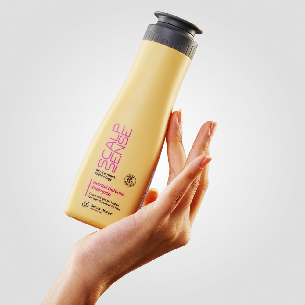 ScalpSense Hairfall Defense Shampoo bottle, with its striking purple text, stands confidently against a gray background.