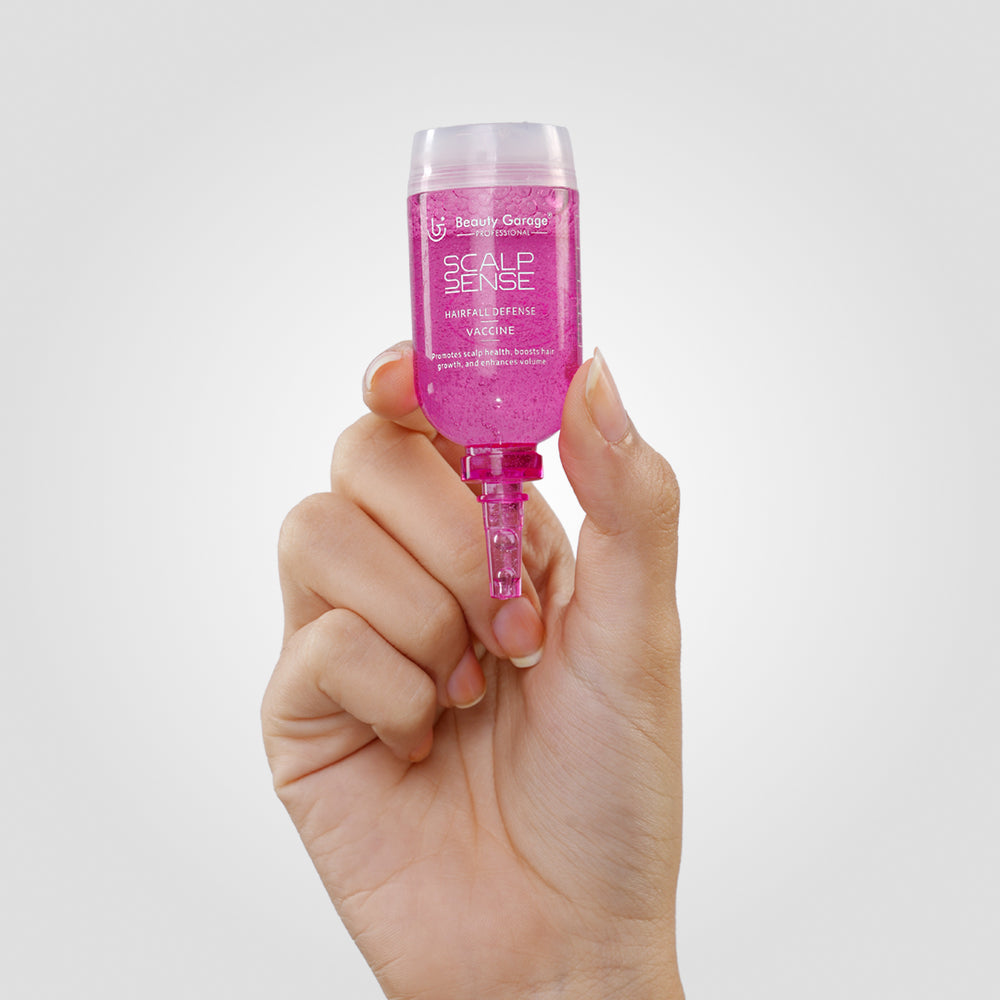 A pink bottle of ScalpSense Hairfall Defense Vaccine by Beauty Garage.