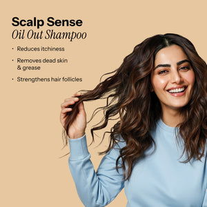 ScalpSense Oil Out Shampoo model, smiles as she gently touches her wavy hair. Benefits: reduces itchiness, removes dead skin 