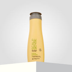 The yellow bottle of ScalpSense Oil Out Shampoo, stands upright on a white and gray surface against a light gray background.