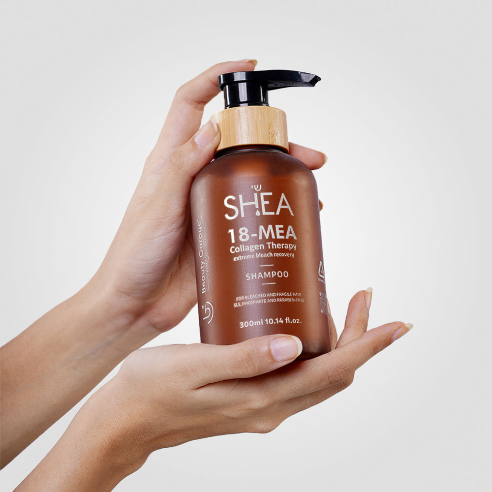 The brown bottle of Shea-18 Mea Collagen Therapy Shampoo, complete with a pump and labeled for bleach recovery.