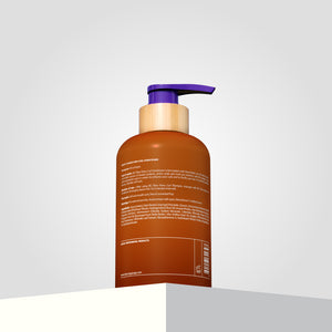 Backshot of the Shea Retention Conditioner in a brown bottle showcasing its ingredient list and text on the rear label.