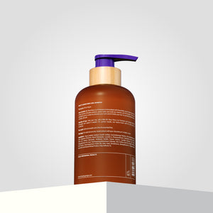 The bottle of Shea Retention Curl Shampoo features a purple pump and has text detailing ingredients.