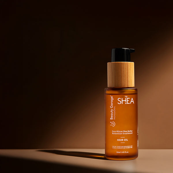 A bottle of Shea Retention hair oil with a wooden cap, labeled "Pure African Shea Butter Retention Treatment,".