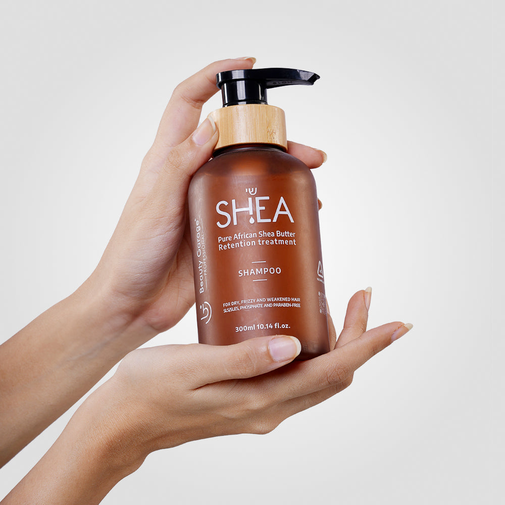 A brown bottle of Shea Retention Shampoo with a pump dispenser, labeled "Pure Shea Butter Retention Treatment".