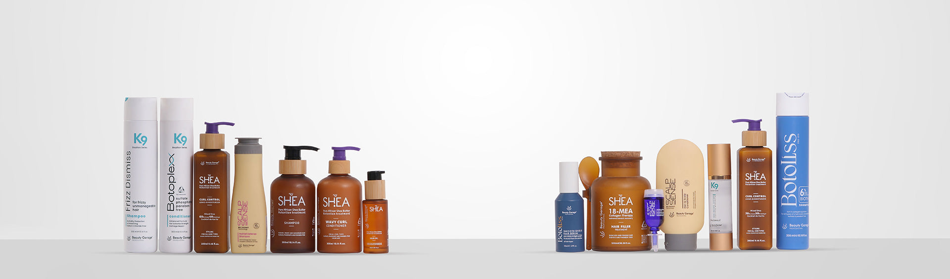 A variety of Beauty Garage hair care products, including bottles and jars, are arranged in a row against a plain background.