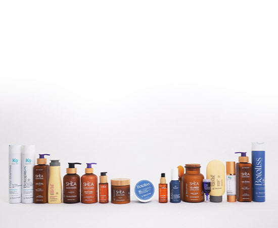 A variety of Beauty Garage hair care products, including bottles and jars, are arranged in a row against a plain background.